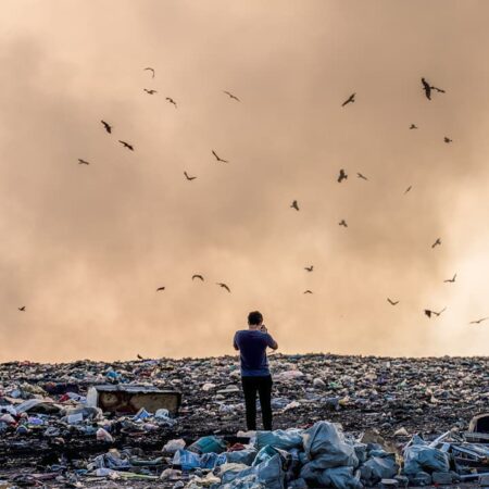 A man surrounded by garbage